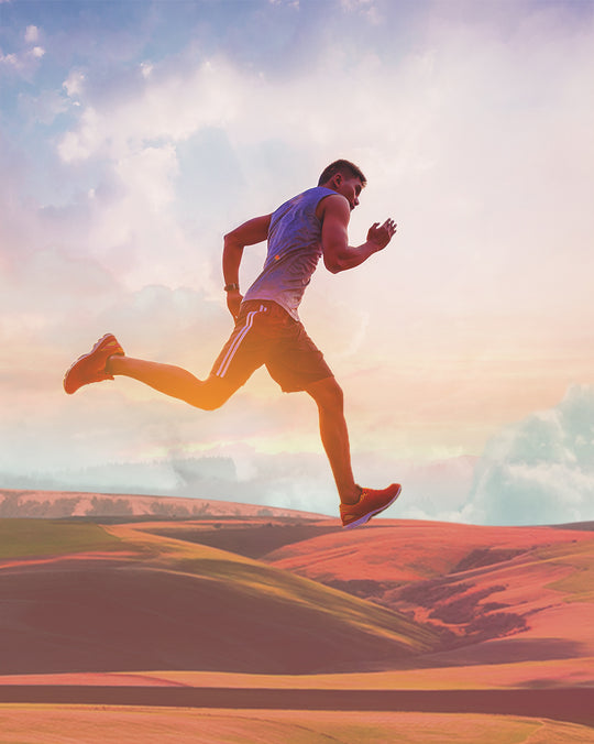 man running across sand dunes 